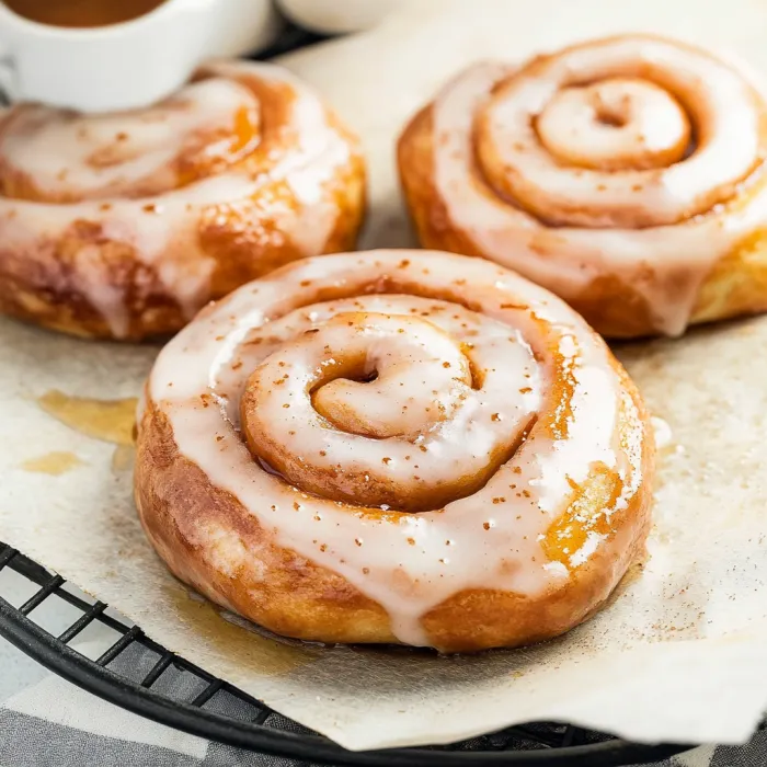 Two glazed donuts on a tray.