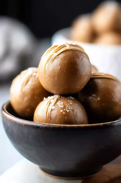 Bowl of balls with sugar on top.