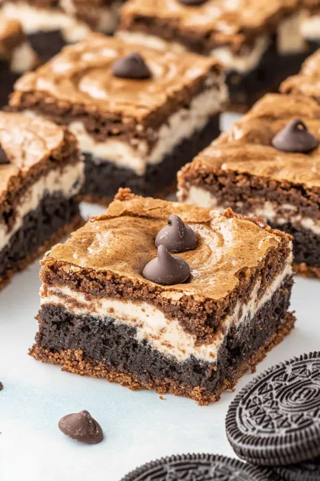 A slice of chocolate cake with chocolate chips.