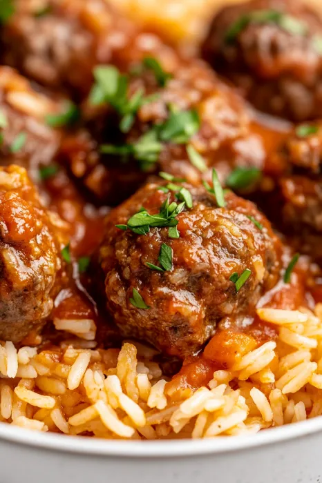 A close up of a bowl of meatballs in a red sauce.