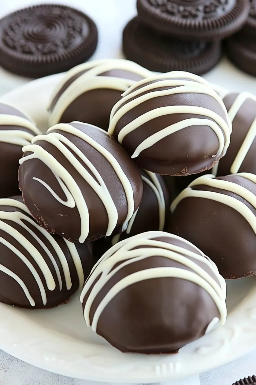 Truffles coated with chocolate and striped with white chocolate.